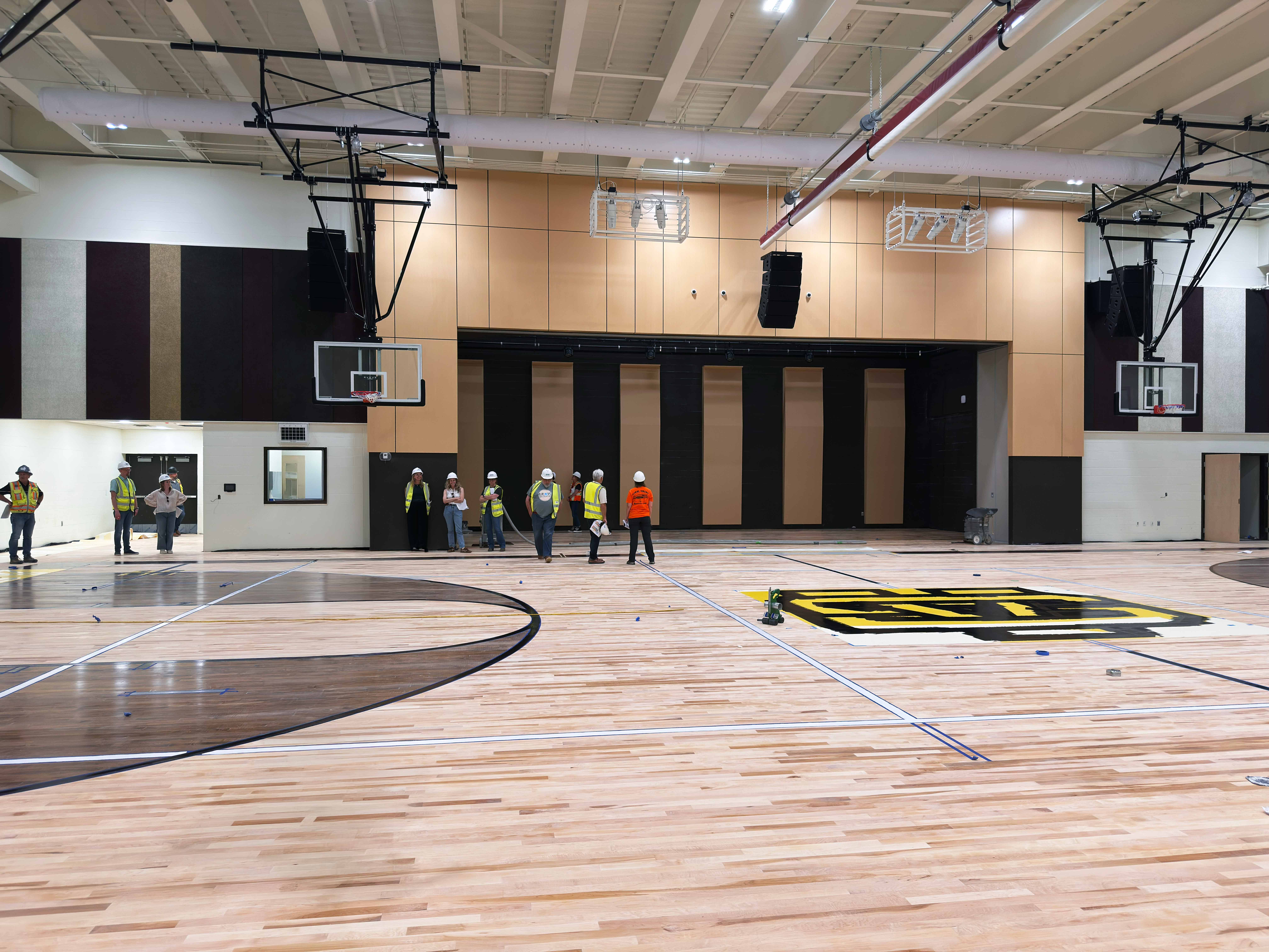 Brand new elementary school gym with school pride colors of maroon and black