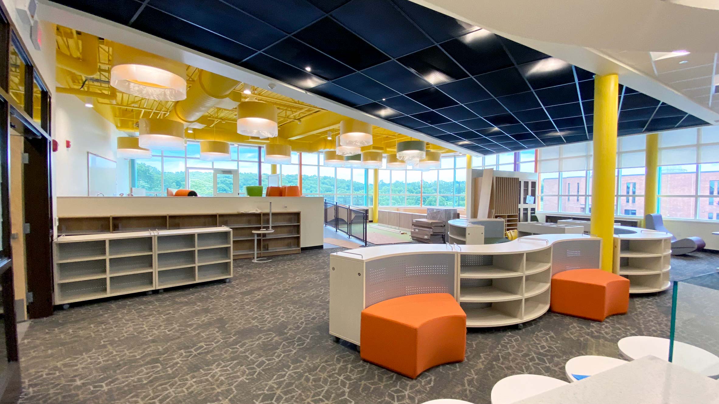 The second floor media center featuring a story time nook, colorful furniture, and lots of natural lighting