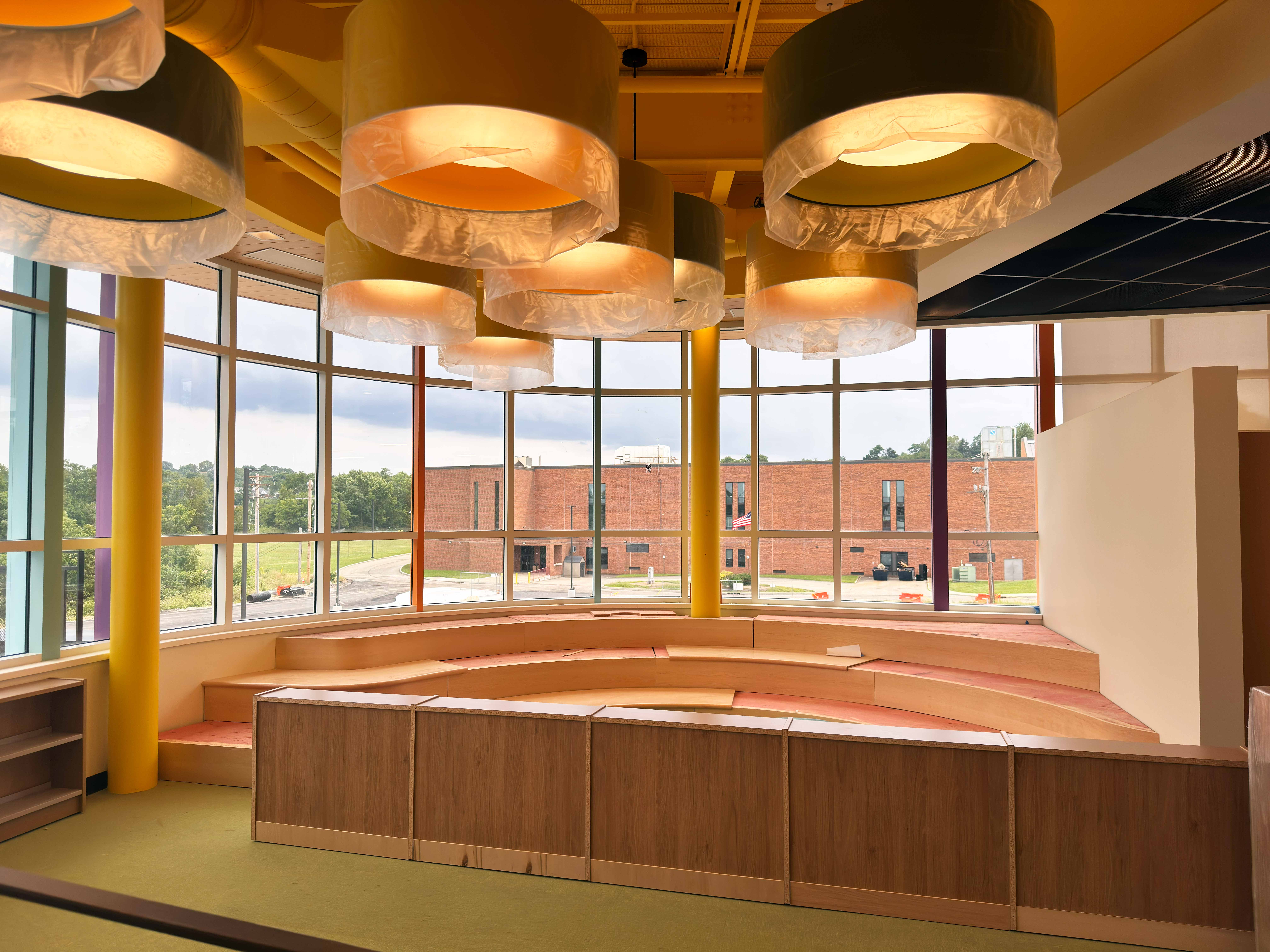 Curved wooden stairs in the media center dedicated for story time